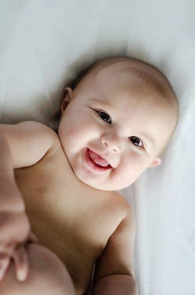 A girl with a baby on a bed